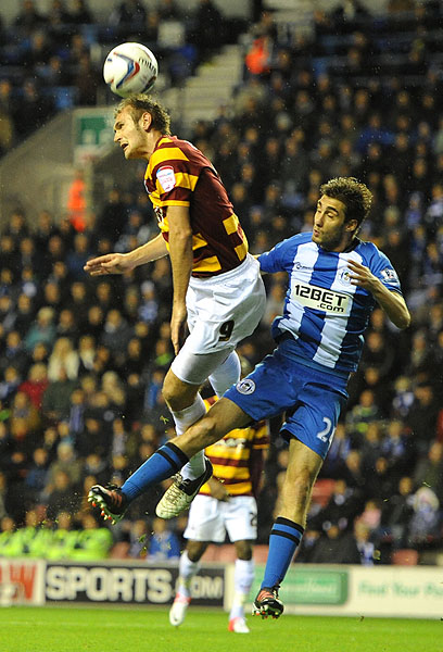 Bradford City's James Hanson out-jumps the Wigan Athletic defence